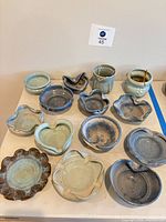 Group shot of all 14 ceramic pieces on table