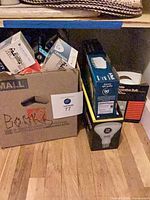 Assorted loose and boxed light bulbs on floor