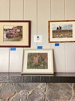 Overview of all three framed photographs on wall/shelf