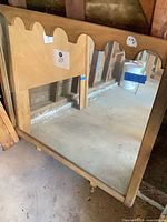 Front view showing full mirror and scalloped wood frame