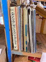 Vertical stack of vinyl record albums and a hardcover art book