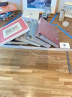 Stack showing all four sealed albums and framed Moses print