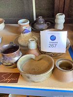 Group shot of assorted Robert M. Shapiro pottery on shelf
