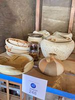 Overall view of multiple Shapiro pottery pieces on shelf