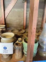 Group showing various pottery pieces on shelf