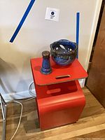 Side table with two ceramic pieces displayed