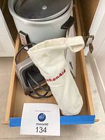 Drawer with rice cooker, KitchenAid bag containing attachments and power cords