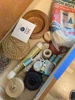 Overview of box contents including nylon rope bag, wicker bowl, baseball, twine rolls, snap hooks tray