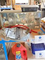 Overall view of storage cabinet, fasteners and hose assembly