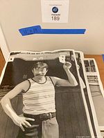 Stack of 11×14 prints with man in striped tank top image