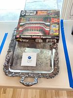 Both items: boxed Spicy Shelf organizer atop silver-plated tray