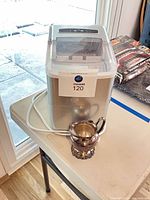 Ice maker front and creamer together on table
