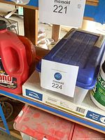 Shelf view showing Bemis toilet seat box, clear tote of screwdrivers, Drano bottle