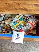 Drawer containing numerous folded maps and travel booklets