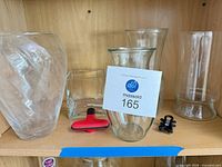 All five glass vases and both magnetic clips on shelf