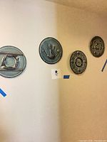 Four ceramic discs mounted on wall showing overall set