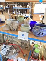 Overall view of ceramics and cobalt glass vase on shelf