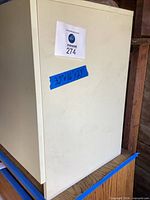 Front view of white cabinet showing off-white finish