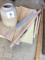 Group shot of urn, plywood, mesh, dowels, copper pipe and trim board