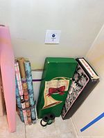 Grouping of gift-wrap rolls, decorative storage boxes and ribbon spools