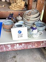 Group view showing pottery collection and hanging discs
