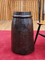 Front view showing full height, faceted surface, ring band, and feet