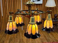 Chandelier lit showing yellow glow through stained glass shades