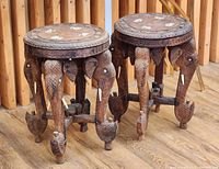 Two carved teak stools with elephant head legs and bone inlay tops