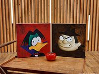 Front view of both square canvases on display