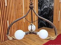 Full view of chandelier hanging with bulbs lit