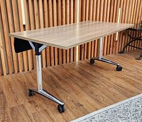 Table in use position showing top, legs, casters