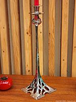 Full view of candlestick on table with candle inserted