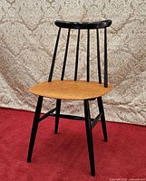 Front three-quarter view of Fanett chair showing seat, spindle back and legs