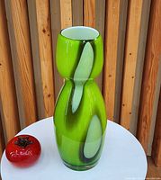 Front view of green cased glass hourglass vase