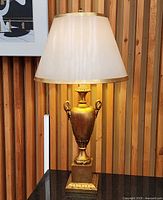 Full view of lamp lit with shade, showing overall design and scale