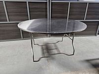 Full view of stainless steel round table top and legs