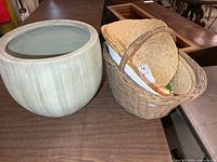 Large resin planter beside wicker basket holding contents
