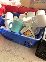 Basket with assorted coffee mugs showing variety and quantity
