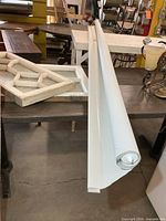 Full view of rolled blind on table showing length and bottom rail