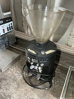 Full view of Mahlkonig grinder with hopper and cord