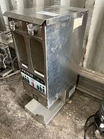 Front view of Fetco stainless dual-hopper coffee grinder