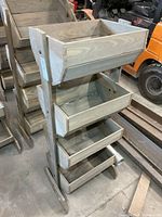 Full view of wooden rack with four tilting bins