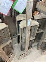 Front view of disassembled wooden display stand components