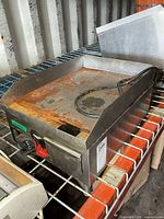 Front angled view of Vollrath stainless electric griddle showing control panel, power cord and rusted cook surface