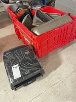 Kruger Titan dispenser beside red crate filled with metal trays