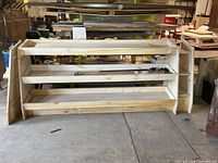 Front view of solid wood three-tier display stand