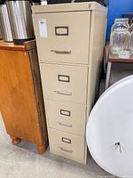 Front view of beige four-drawer metal file cabinet