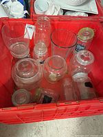 Overview of red tote showing assorted glass jars, canisters, vase and cookie jar