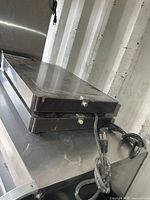 Stacked view of two stainless hot plate warmers with cords