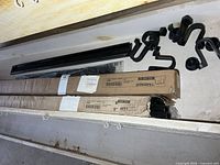 Two IKEA Tarendo boxed frame components with loose parts in wooden bin